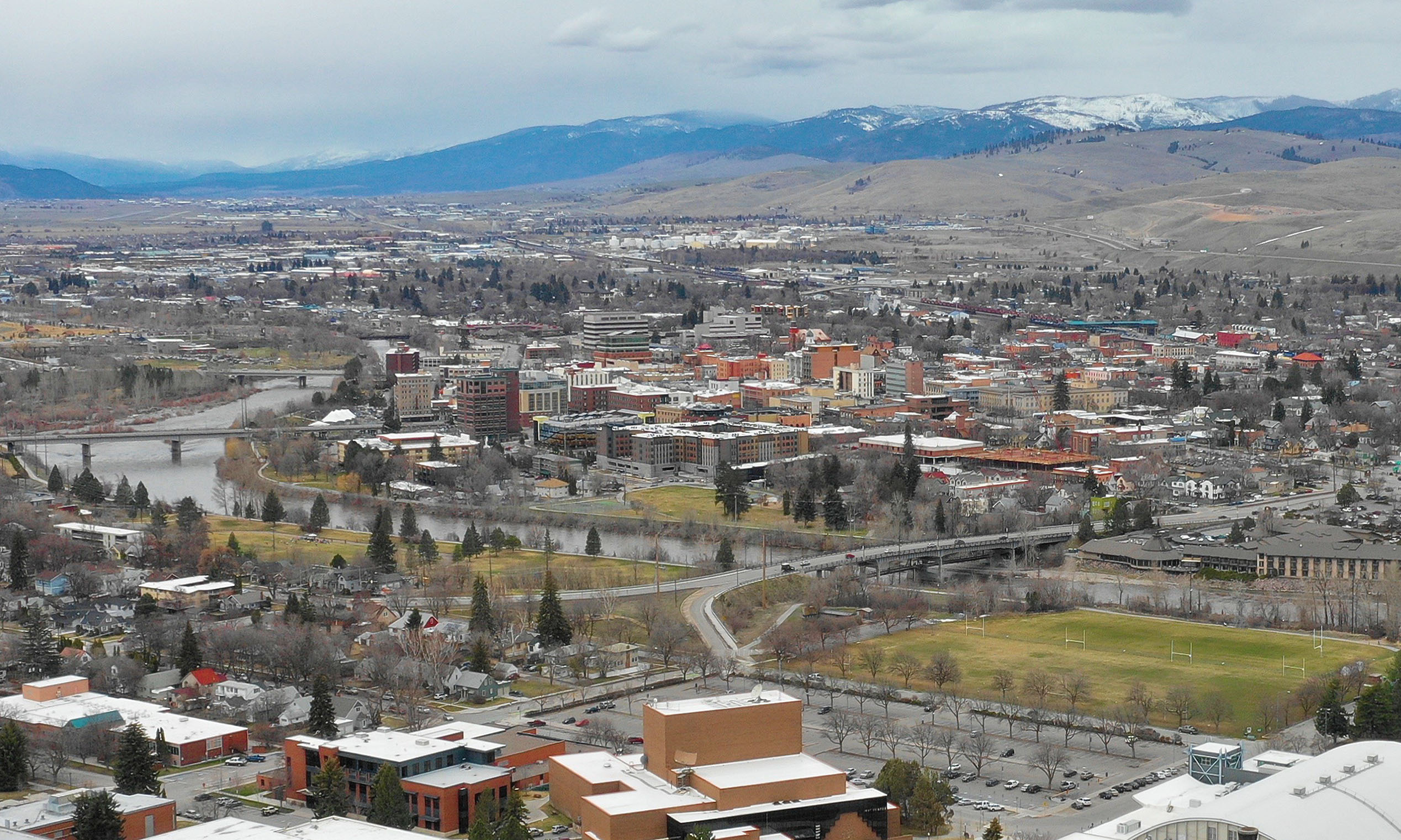 Missoula buildings and river with hills beyond.