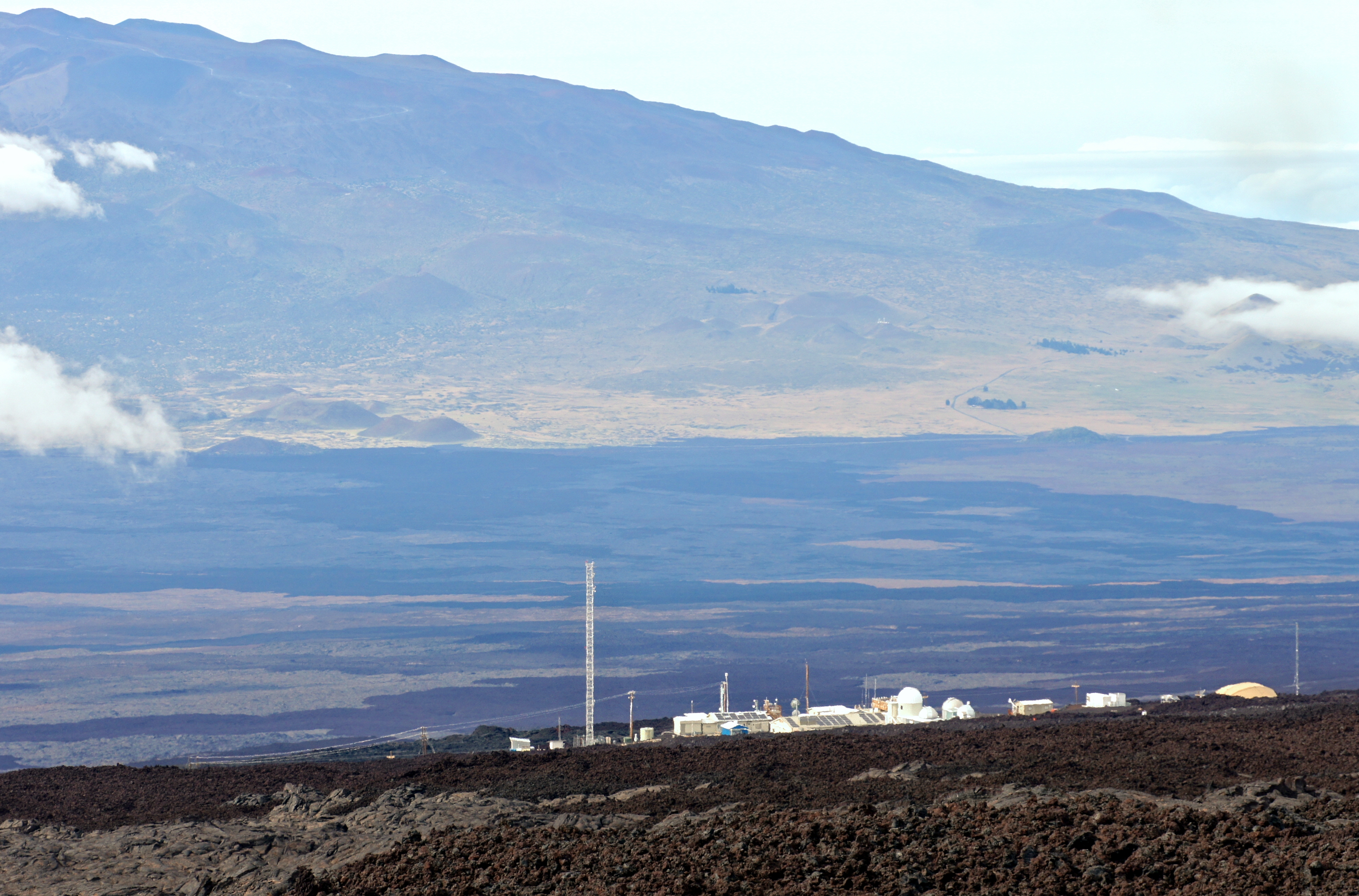 Buildings of the Mauna Loa Observatory on volcanic terrain.