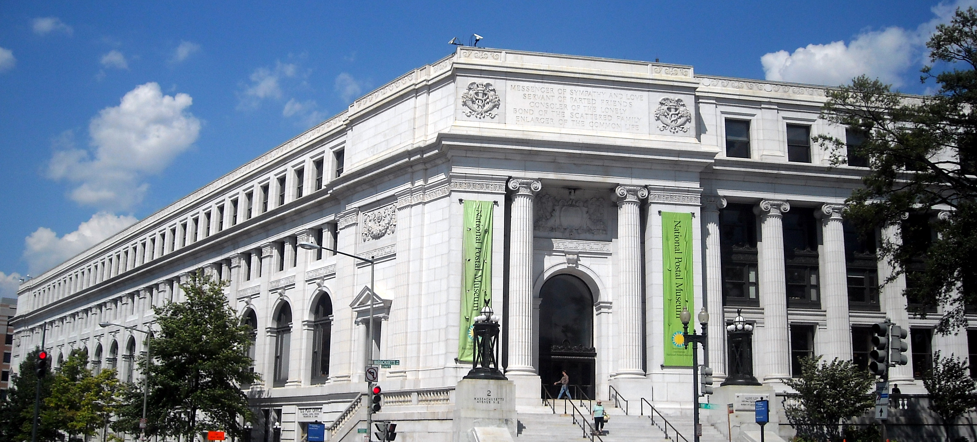 The long stone facade of the Postal Square Building beside a Washington street.
