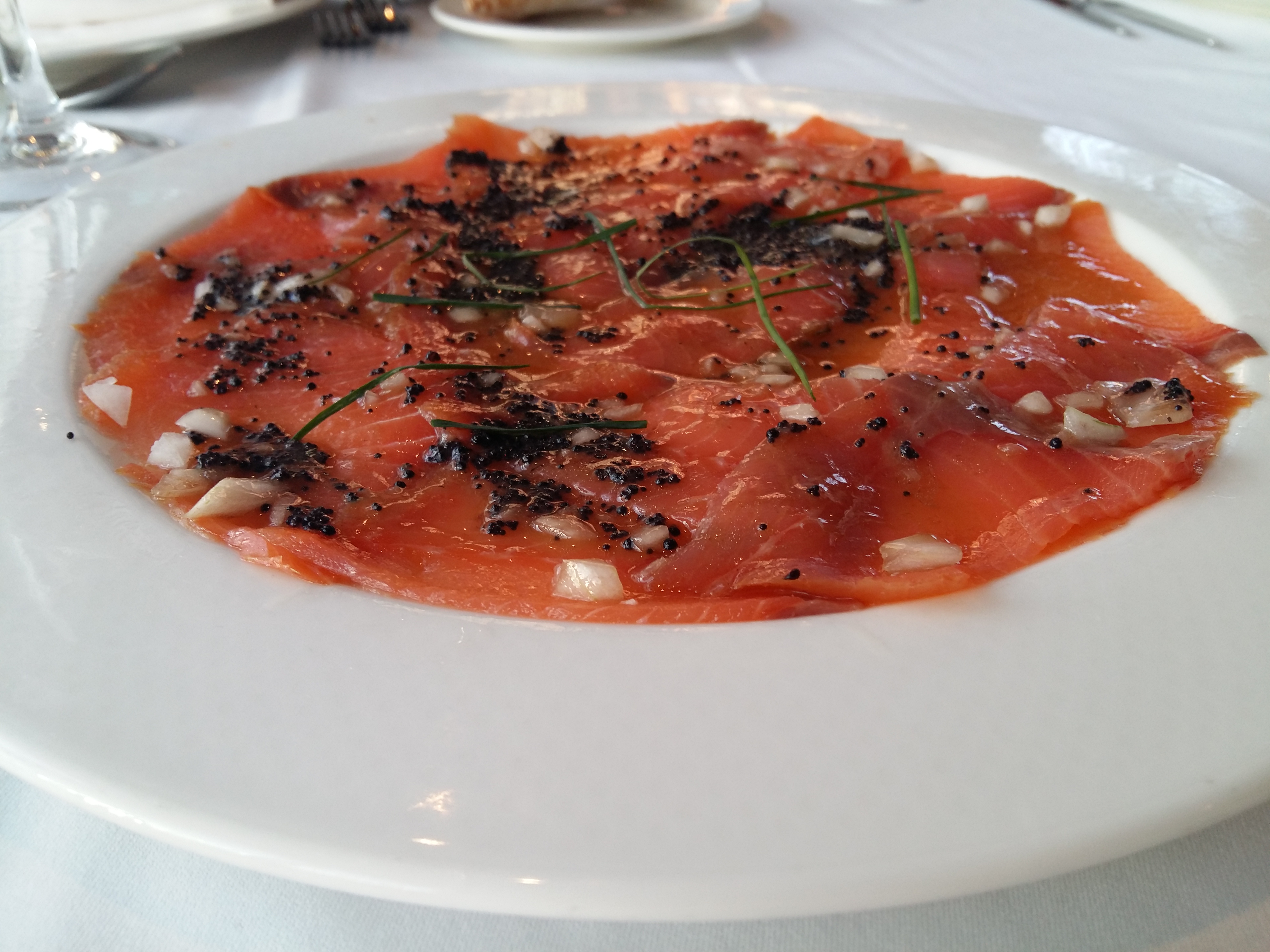 Sliced smoked salmon served on a plate.