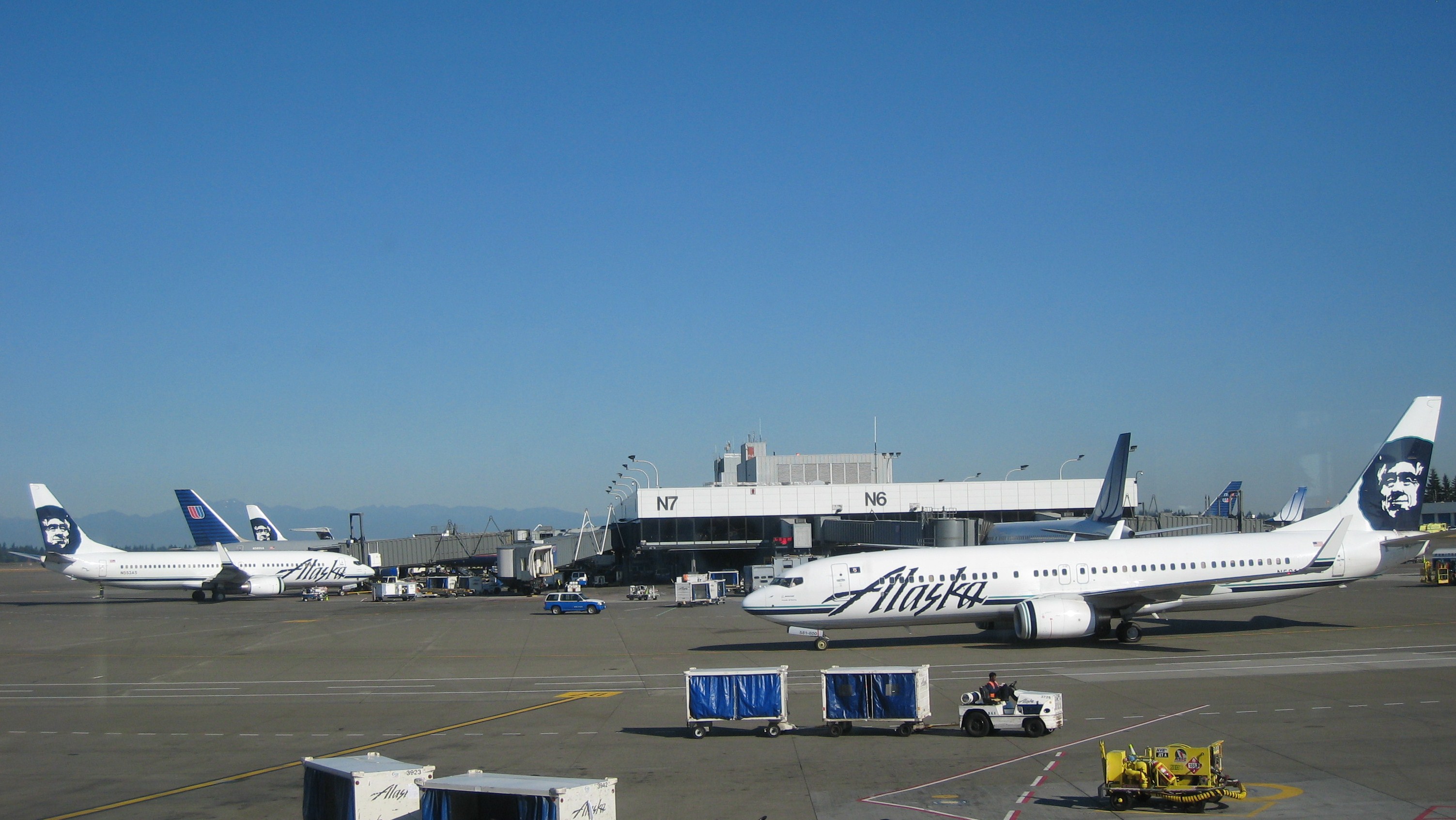 Archive view of Seattle–Tacoma’s north terminal with aircraft at gates and ground equipment in front.