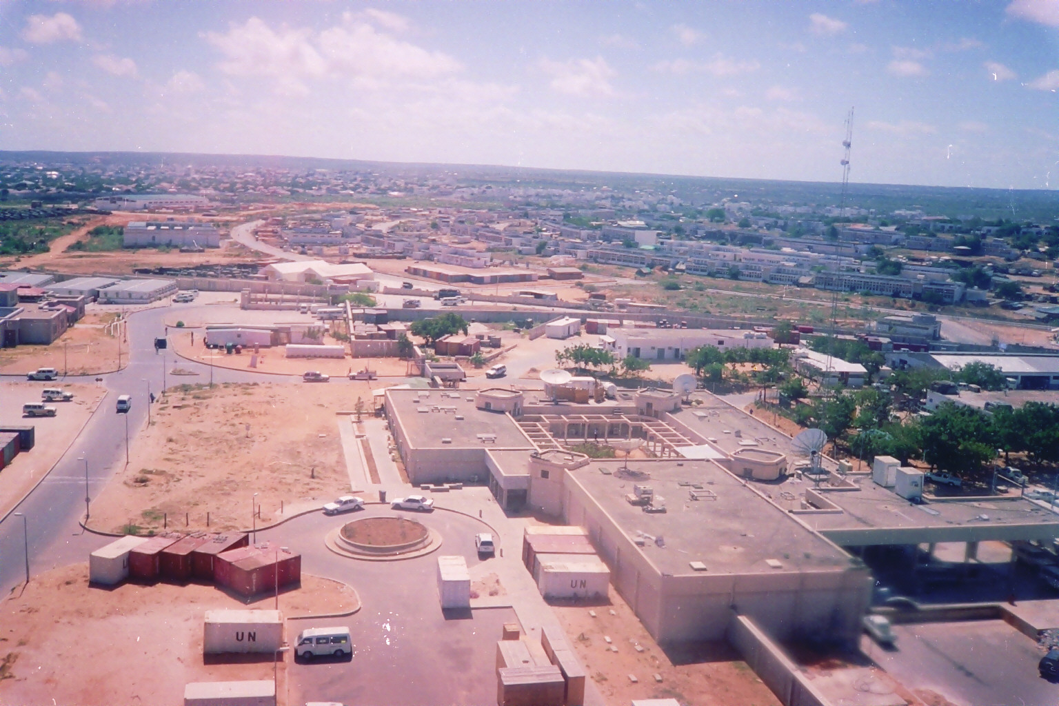 An aerial archive view of buildings, roads and UN-marked containers in Mogadishu.