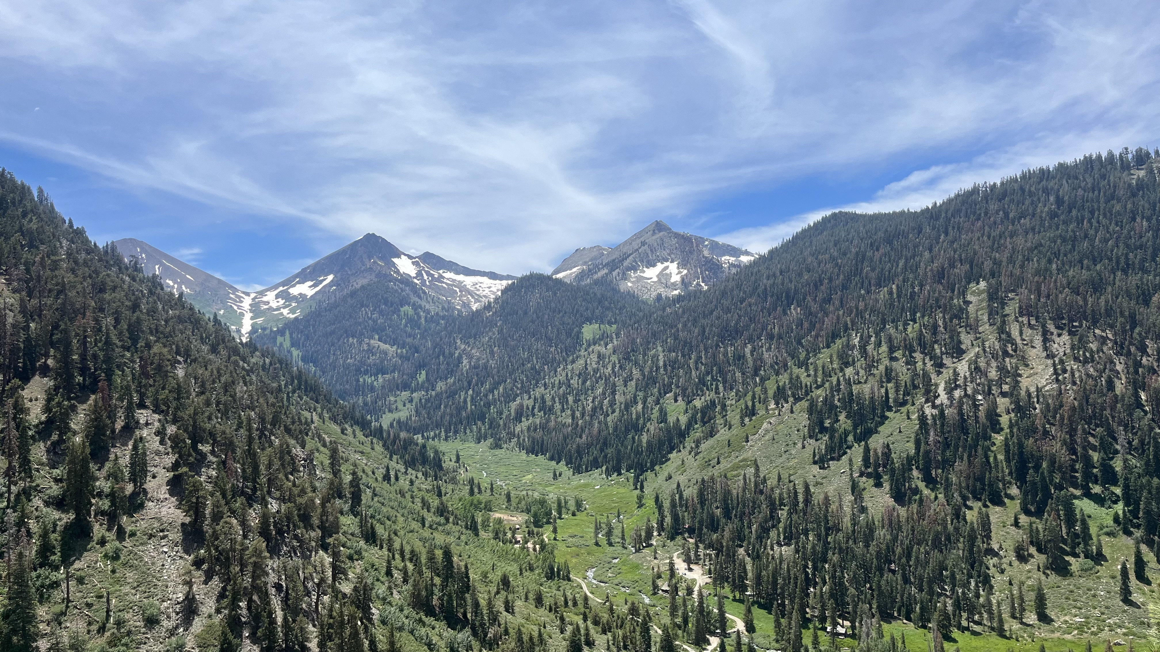 Mineral King valley with a river, trees and mountain peaks.