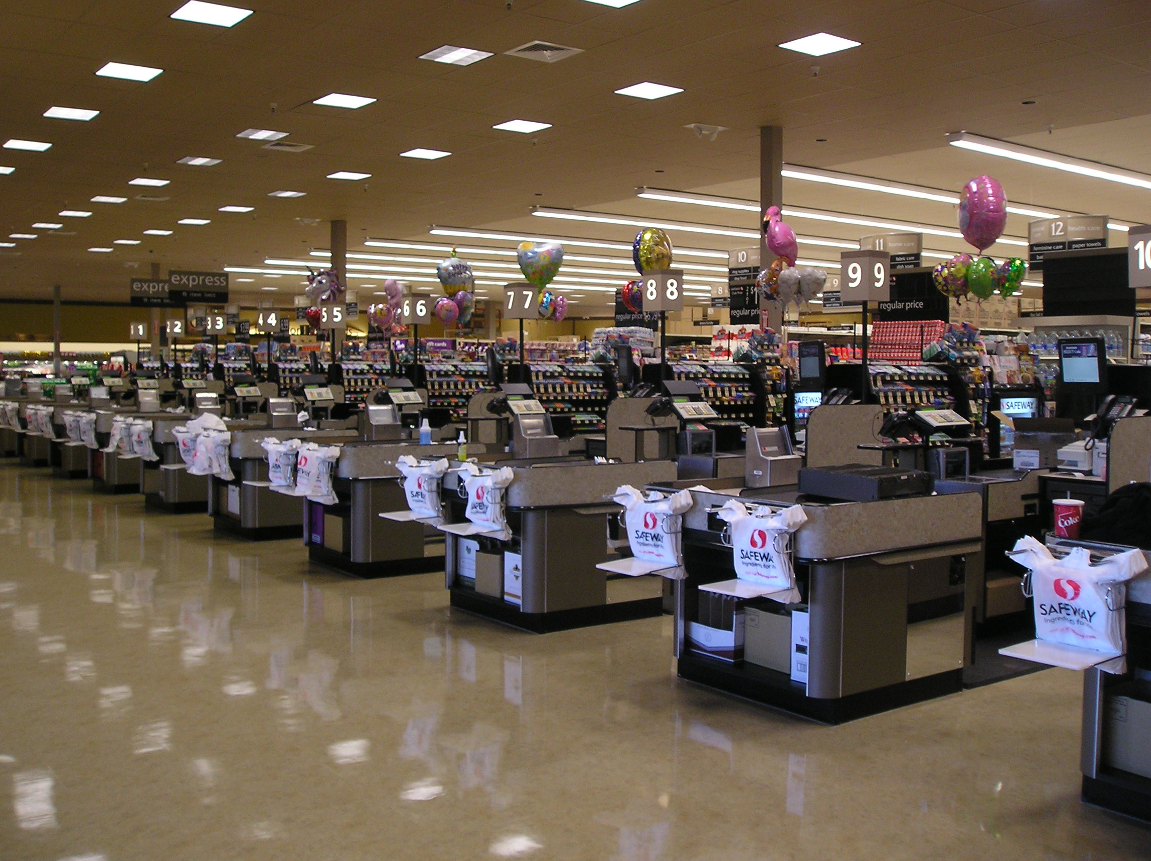 Empty checkout lanes inside a United States Safeway supermarket before opening.
