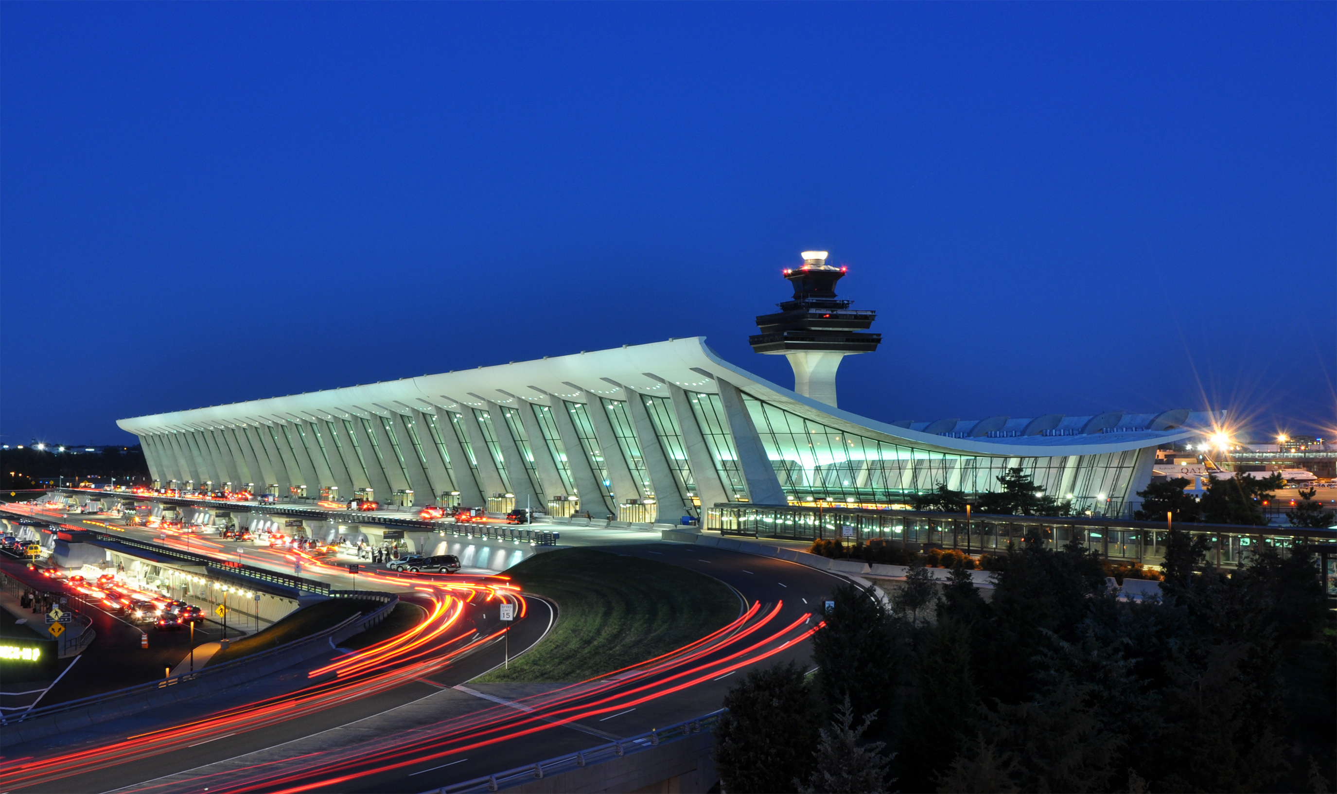 Dulles airport’s main terminal and control tower illuminated at dusk.