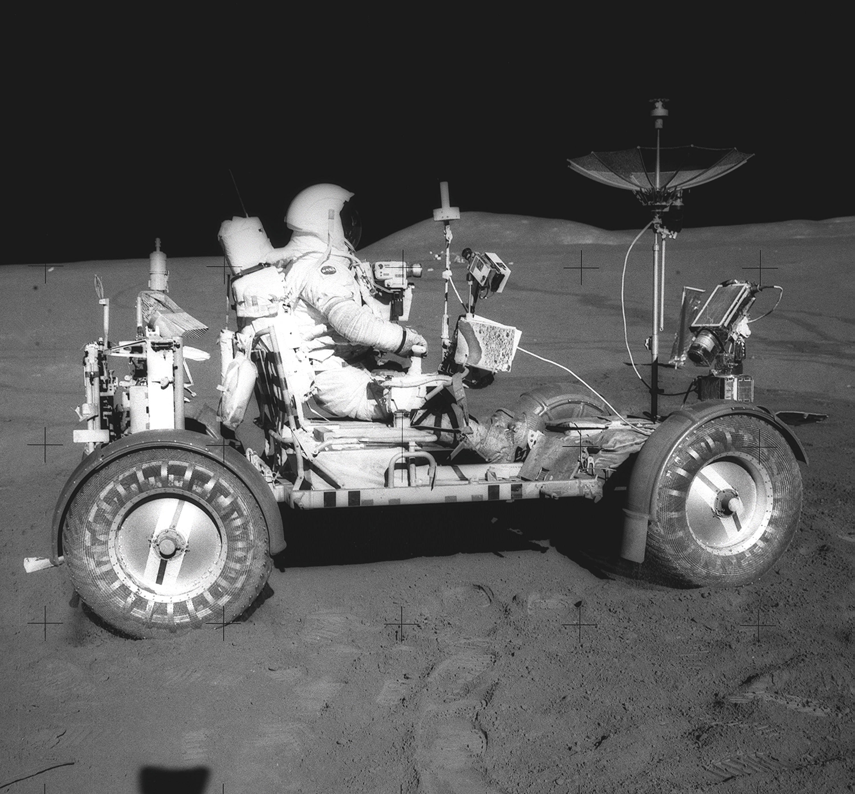 Apollo 15 astronaut David Scott seated in the lunar rover.